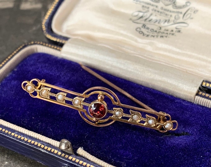Victorian gold brooch. 9ct yellow gold with delicate seed pearls and a single round facet cut red garnet gemstone.