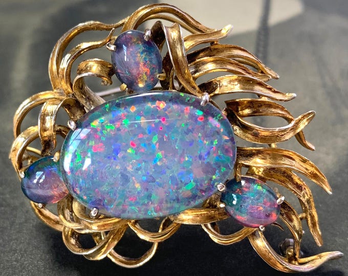 1950s Black Opal brooch. Silver gold gilt with stunning Black opal triplet cabochons. 15 grams