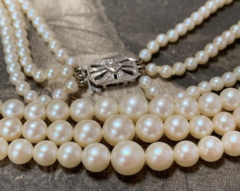 Triple strand Pearl Necklace with Diamond set gold clasp. Princess length 277 cultured pearls. 7.5mm-3.5mm 9ct white gold diamond clasp