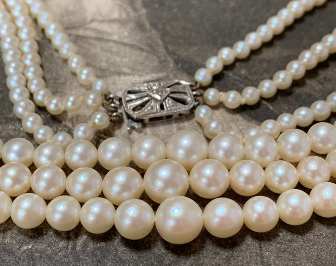 Triple strand Pearl Necklace with Diamond set gold clasp. Princess length 277 cultured pearls. 7.5mm-3.5mm 9ct white gold diamond clasp