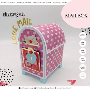 May include: A pink mailbox with a heart pattern and a blue lock. The mailbox has a white envelope with a gold seal in the slot. The mailbox is labelled "LOVE MAIL" and "MAILBOX".