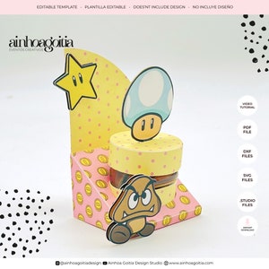 May include: A printable template for a party favor box featuring a yellow star, a blue mushroom, and a brown mushroom character. The box is decorated with pink and yellow polka dots and gold coins. The text "ainhoagoitia" and "EVENTOS CREATIVOS" is visible at the top of the image. The text "VIDEO TUTORIAL", "PDF FILE", "DXF FILES", "SVG FILES", "STUDIO FILES", and "INSTANT DOWNLOAD" is visible on the right side of the image.
