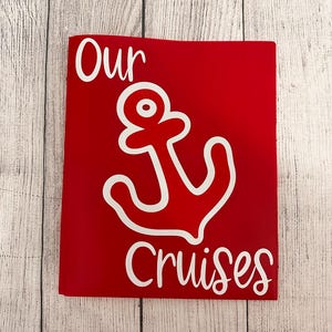 May include: Red scrapbook with a white anchor and the text "Our Cruises" on the front.