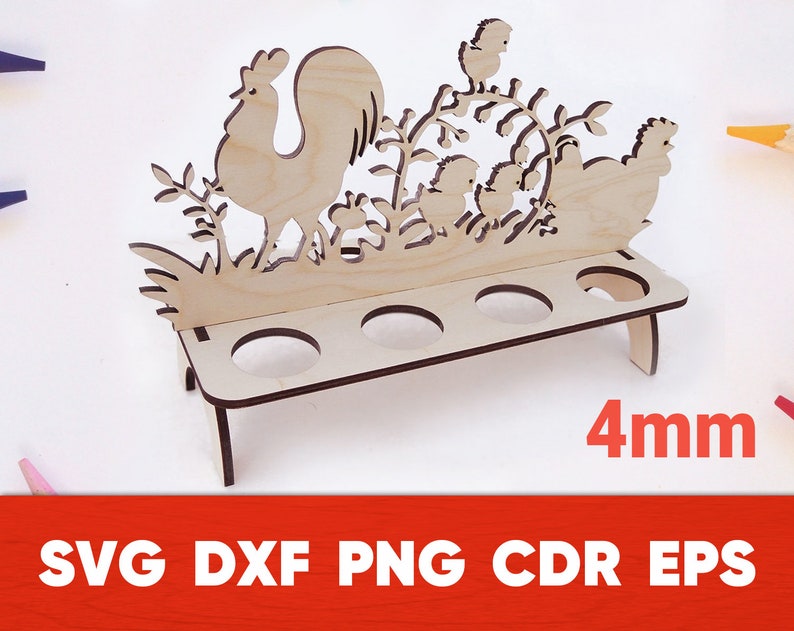 May include: Wooden egg holder with a rooster and chicks design. The holder has five slots for eggs and is 4 mm thick.