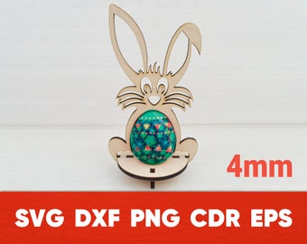 May include: Wooden bunny rabbit egg holder with a green, blue, and pink patterned egg. The holder is 4mm thick. SVG, DXF, PNG, CDR, EPS.