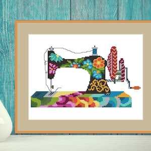 May include: A colourful floral patterned sewing machine with a spool of thread and a needle. The machine is on a floral patterned base.