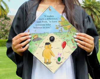 May include: A graduation cap with a Winnie the Pooh illustration and the quote "It makes such a difference," said Pooh, "to have someone who believes in you."