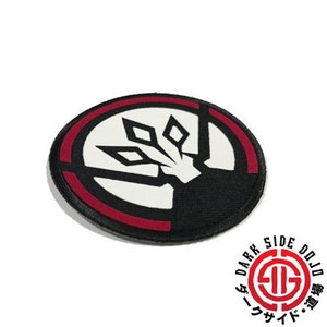 May include: Black, red, and white embroidered patch with a stylized emblem. The patch features a circular design with a black outer ring, a red inner ring, and a white central design. The text "DARK SIDE DOJO" is also visible.
