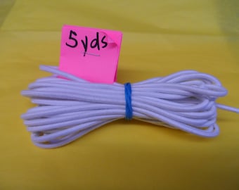 May include: White elastic cord, 5 yards long, bundled and tied with a blue rubber band.