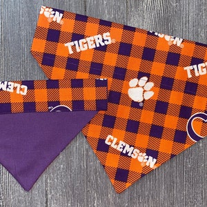 May include: Two orange and purple plaid dog bandanas with the text "Clemson Tigers" and a paw print.