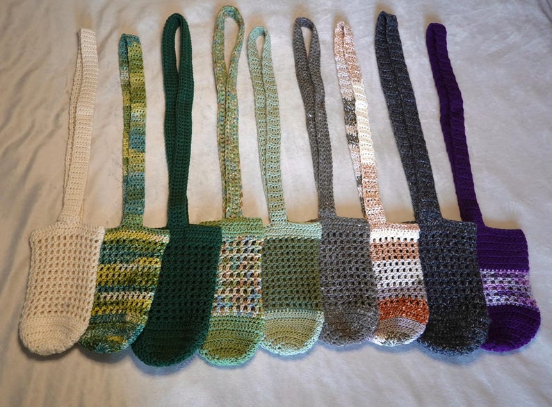May include: Nine crocheted bags with different colored patterns. The bags are made with a variety of colors, including white, green, brown, and purple. The bags have a simple design and are perfect for carrying small items.