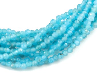 May include: A strand of light blue gemstone beads. The beads are faceted and have a slightly irregular shape.