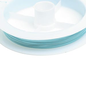 May include: A spool of light blue thread wound around a white plastic bobbin.