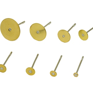 May include: Assortment of eight gold-toned earring posts with different sized round discs. The earring posts are made of metal and have a silver-toned finish.