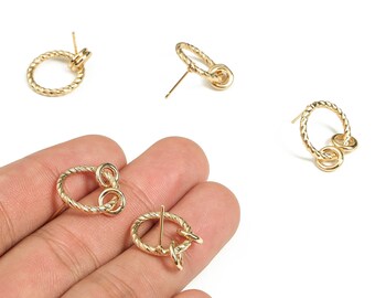 May include: Gold-colored earrings with a textured, rope-like design. The earrings feature a post and a small, connected loop. The design includes a small, connected loop. The earrings are displayed on a white background.