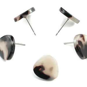 May include: Four pairs of earrings with a tortoiseshell pattern. The earrings are round and oval shaped with silver posts.