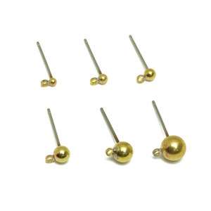 May include: Six gold-toned earring findings with a loop and a small ball at the end. The findings are on a white background.