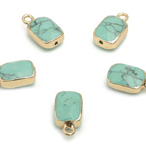 May include: Five turquoise gemstone charms with gold-toned metal settings. Each charm has a loop for attaching to jewelry.