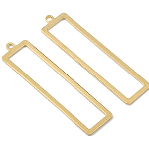 May include: Two gold-coloured rectangular pendant charms with a loop at the top for attaching to a chain or other jewellery component. The charms are open-framed, with a simple, clean design. Ideal for DIY jewellery making.