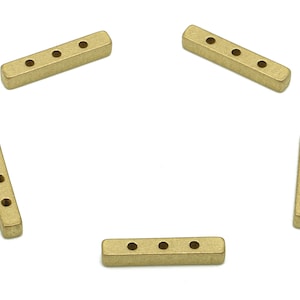 May include: Five gold-colored metal bar connectors with four holes each. The connectors are arranged in a star shape.