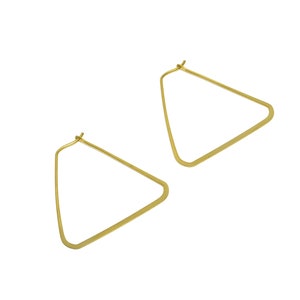May include: A pair of gold triangle hoop earrings. The earrings are simple and elegant.