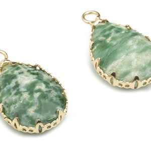 May include: Two green and white agate gemstone pendants with gold settings. The pendants are teardrop shaped and have a delicate, ornate design.