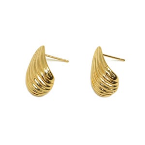 May include: A pair of gold-toned earrings with a textured, ribbed, teardrop shape.