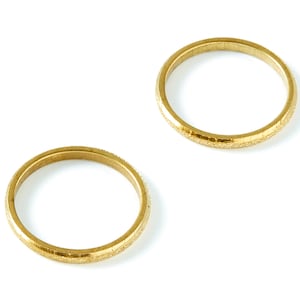 May include: Two gold-coloured wedding bands with a textured finish.