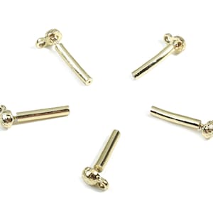 May include: Five gold-toned metal connector pieces with a textured round end and a smooth cylindrical section.