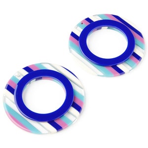 May include: A pair of blue, white, and pink striped earrings with a blue circle in the center.