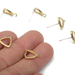 May include: Gold-colored triangle-shaped earring posts with a loop for attaching charms. The earrings have a post for piercing and are shown on a white background. Several earring posts are visible.
