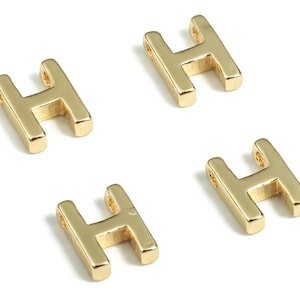 May include: Four gold-colored metal letter H charms. Each charm has a hole at the top for attaching to a necklace or bracelet.