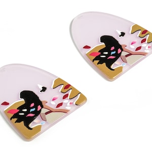 May include: Two purple and gold earrings with a black silhouette and colourful accents.