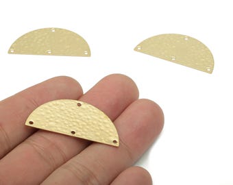 May include: Three gold-colored, half-circle shaped metal jewelry components with a hammered texture. Each piece has three holes for attaching to other components. One piece is held in a hand.