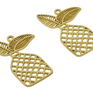 May include: Two gold-colored metal pineapple charms with a cutout design. Each charm features a pineapple with leaves and a grid pattern.