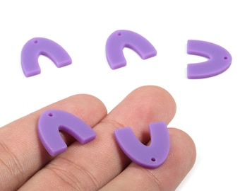 May include: Five lavender-colored, U-shaped acrylic charms with a small hole at the top for jewelry making. Two charms are held in a hand. The charms are smooth and have a matte finish.