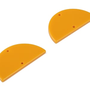 Può includere: Due forme di acrilico arancione a forma di semicerchio con due fori ciascuna.