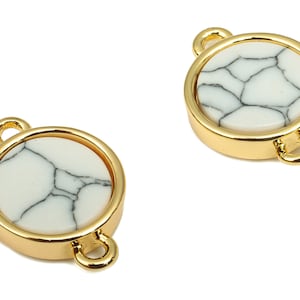 May include: Two gold-toned metal connector charms with white and black marbled stone inserts. Each charm has two loops for attaching to jewellery.