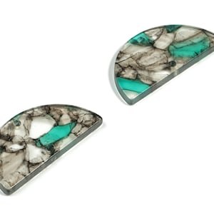 May include: Two half-circle resin earrings with a marbled pattern in shades of gray and teal.