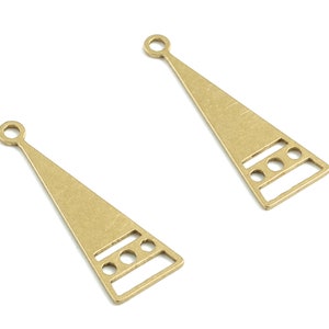 May include: Two gold-toned metal triangle-shaped charms with a geometric design and a loop at the top.