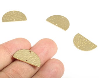 May include: Four gold-coloured, half-circle shaped metal jewellery findings. Each piece has a hammered texture and two small holes for attaching to other components. The findings are shown against a white background.