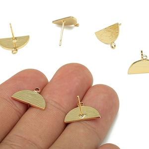May include: Gold-colored, half-circle shaped earring components. Some have a post for piercing, others have a small loop for attaching to other jewelry pieces. The earrings have a textured surface and are displayed on a white background.