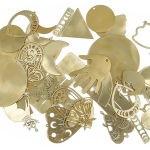 May include: A collection of brass metal shapes, including circles, hearts, moons, butterflies, and a hand. The shapes have intricate cutouts and designs.