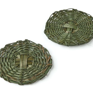 May include: Two round woven green coasters made from natural materials.