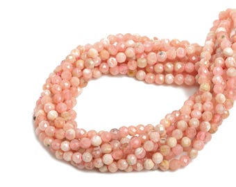 May include: A strand of pink and white gemstone beads. The beads are faceted and have a slightly iridescent sheen.