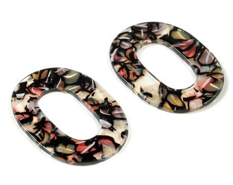 May include: Two oval-shaped, black, white, and brown patterned plastic bag handles.