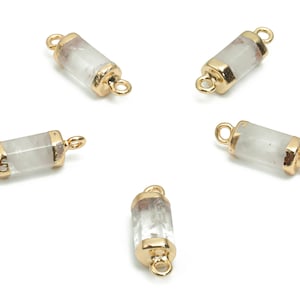May include: Five gold-toned metal connector pieces with clear quartz crystal inserts. Each piece has two loops for attaching to jewelry.
