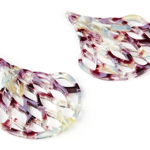May include: Two tortoiseshell hair clips with a lattice design. The clips are a mix of purple, white, and light blue.