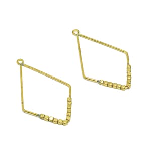 May include: A pair of gold-toned earrings with a diamond shape and a row of small, square beads.