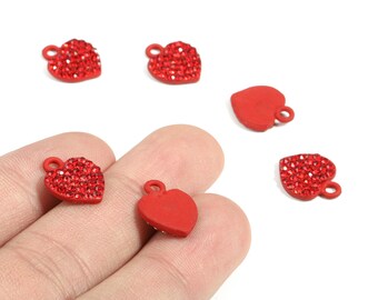 May include: Red heart-shaped charms with small loops for hanging. Some hearts are covered in red rhinestones, while others are solid red. These charms are ideal for jewelry making or craft projects.